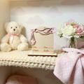 Stork baby birth announcement sign displayed in a soft pastel nursery setting