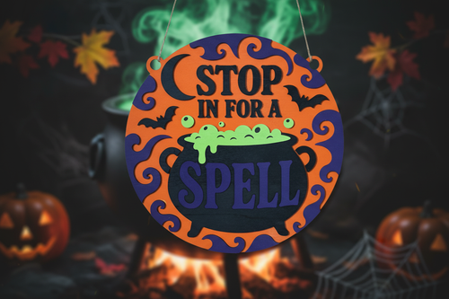 Stop In For A Spell Halloween round door hanger as the focal point with a softly blurred bubbling cauldron and green potion smoke in the background