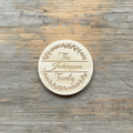 Personalized leafy wreath arc family name wood coaster flat lay on rustic wood background