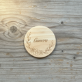 Personalized floral vine name wood coaster flat lay on rustic wood background
