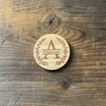 Laser engraved monogram wood coaster flat lay on rustic wood background